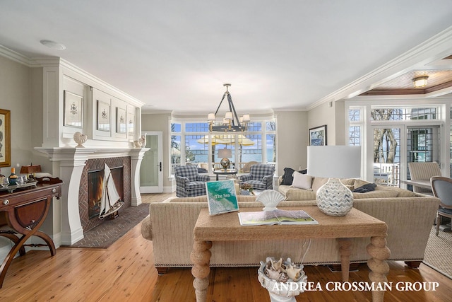 6059 Lakeshore Dr, West Olive, MI 49460 - living area with ornamental molding, light wood-type flooring, a notable chandelier, and a premium fireplace