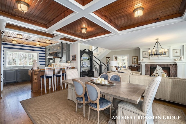 6059 Lakeshore Dr, West Olive, MI 49460 - dining space featuring stairway, coffered ceiling, a fireplace, and wood ceiling
