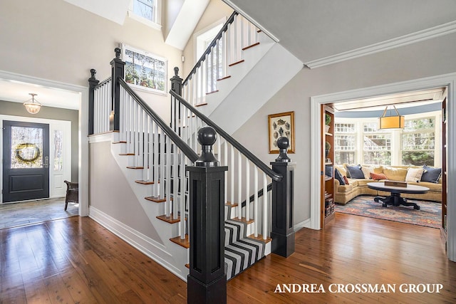 6059 Lakeshore Dr, West Olive, MI 49460 - staircase with wood-type flooring, a high ceiling, plenty of natural light, and baseboards