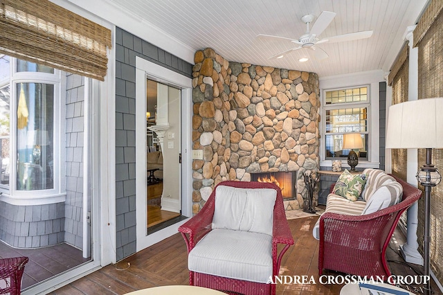 6059 Lakeshore Dr, West Olive, MI 49460 - sitting room featuring a ceiling fan, wood ceiling, wood-type flooring, and a stone fireplace