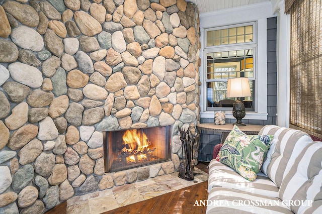 6059 Lakeshore Dr, West Olive, MI 49460 - unfurnished living room featuring a warm lit fireplace, crown molding, and wood finished floors