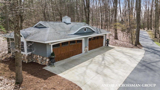 6059 Lakeshore Dr, West Olive, MI 49460 - exterior space with a chimney, a shingled roof, a garage, stone siding, and a forest view