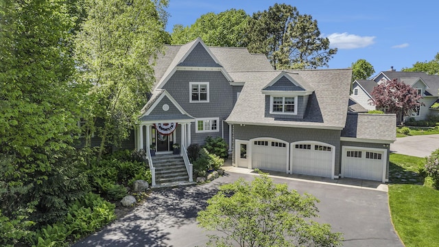 6059 Lakeshore Dr, West Olive, MI 49460 - shingle-style home featuring a garage, aphalt driveway, and roof with shingles