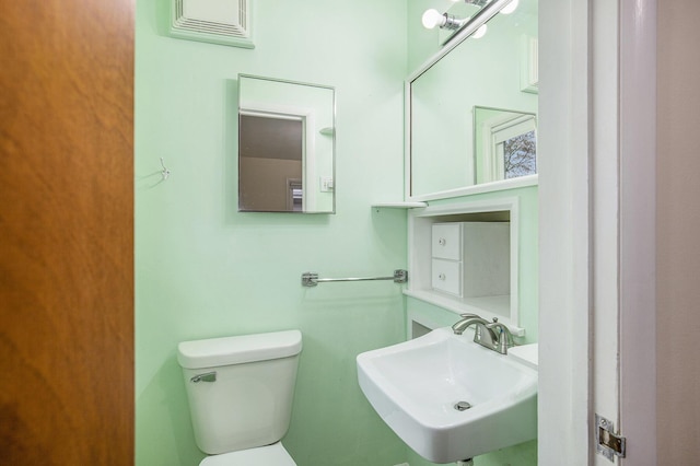 bathroom featuring toilet and a sink