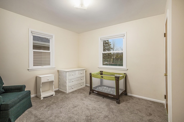 living area featuring carpet floors and baseboards