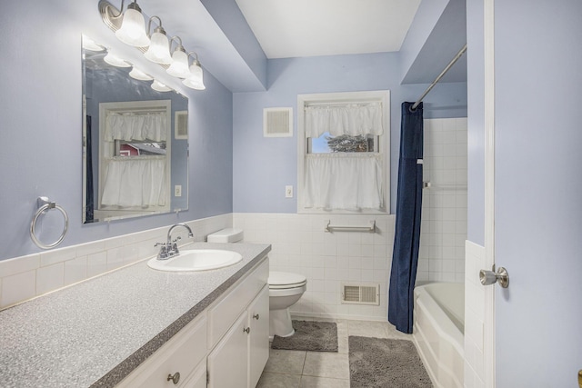 full bath with toilet, tile patterned flooring, visible vents, and tile walls