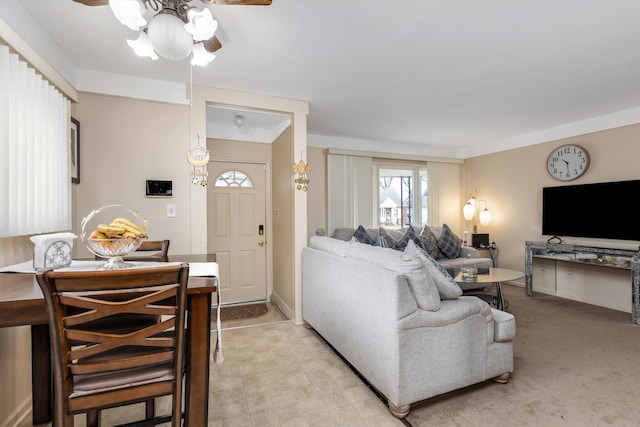 living room featuring light carpet and a ceiling fan