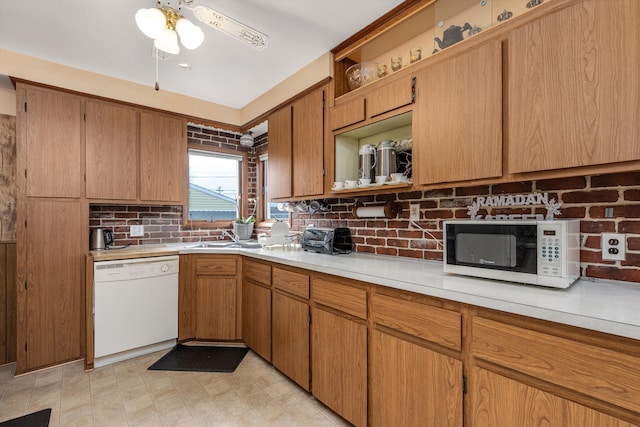 kitchen with white appliances, tasteful backsplash, brown cabinets, light countertops, and open shelves