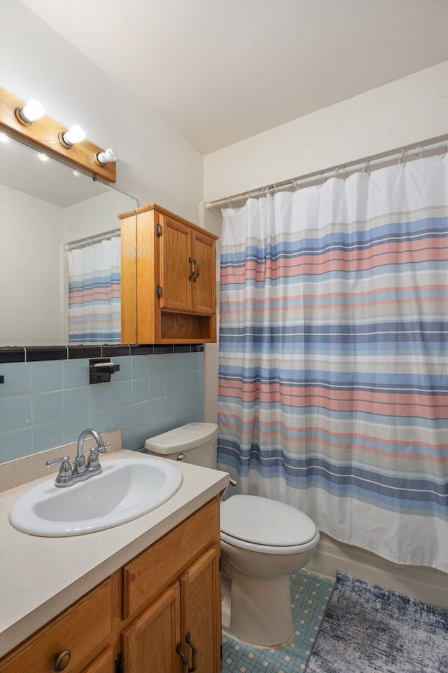 full bath with toilet, curtained shower, tile patterned floors, and vanity