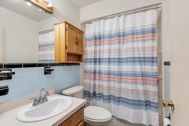 full bathroom with vanity, toilet, and tile walls