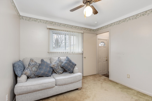 carpeted living room with baseboards and a ceiling fan