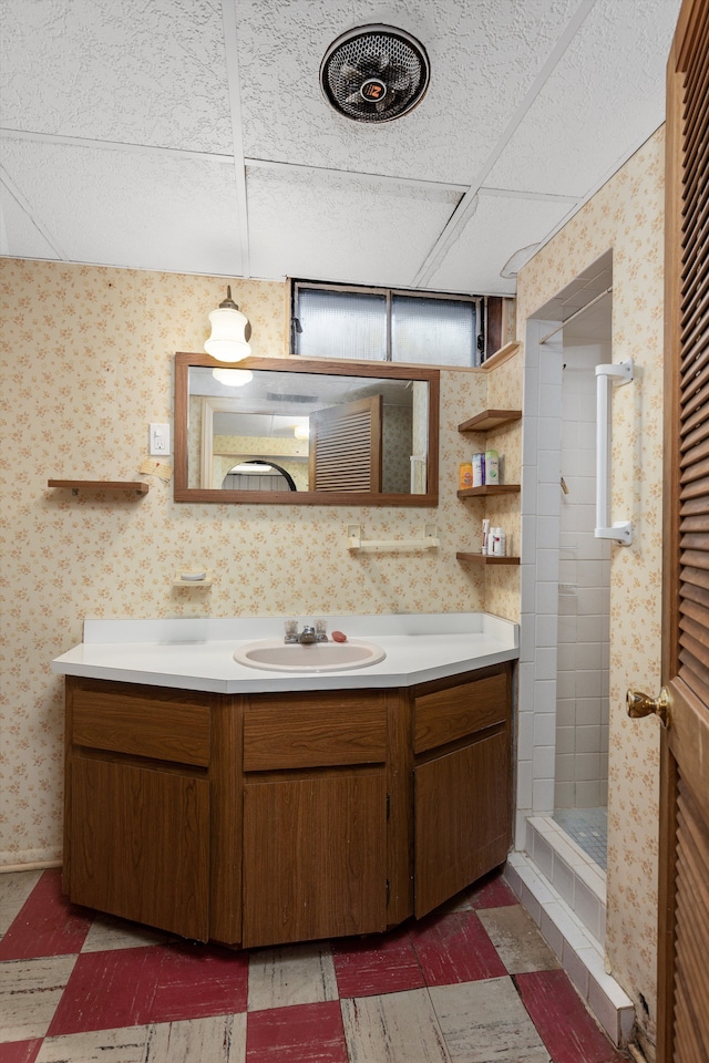 bathroom featuring tile patterned floors, a shower stall, vanity, and wallpapered walls