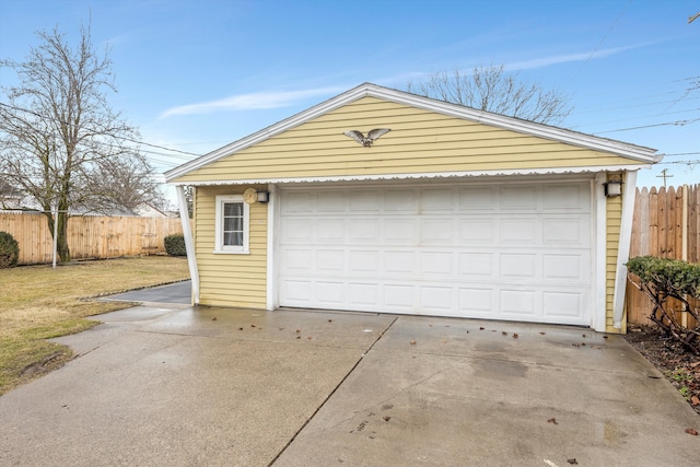 detached garage featuring fence