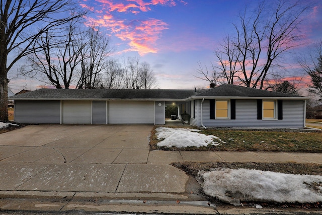 ranch-style house with driveway, a garage, and a chimney