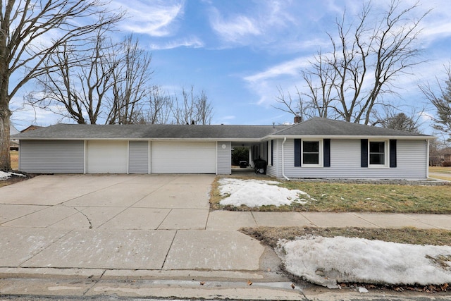 view of front of home with a garage, a chimney, and concrete driveway