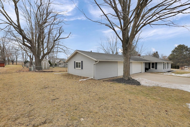 view of front of property featuring an attached garage, fence, and concrete driveway