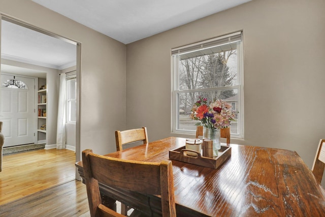 dining area featuring wood finished floors and baseboards