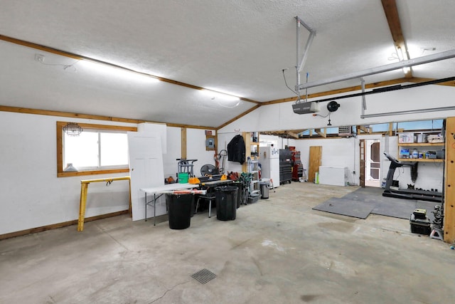 garage with a garage door opener and baseboards