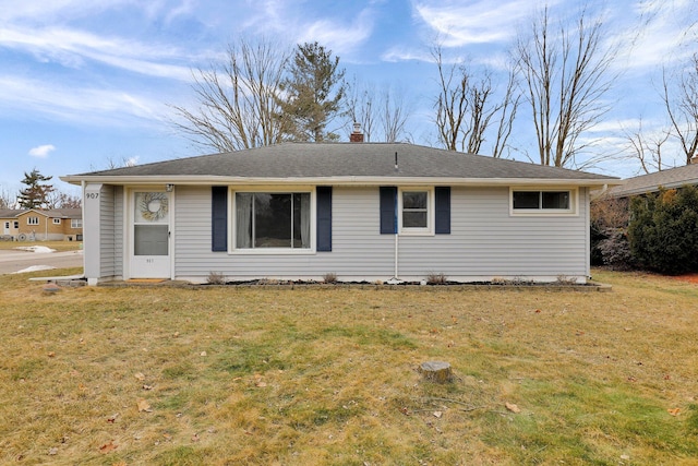 exterior space with a shingled roof, a chimney, and a front lawn