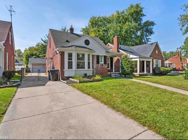 view of front of house with a front yard, a gate, a chimney, and brick siding