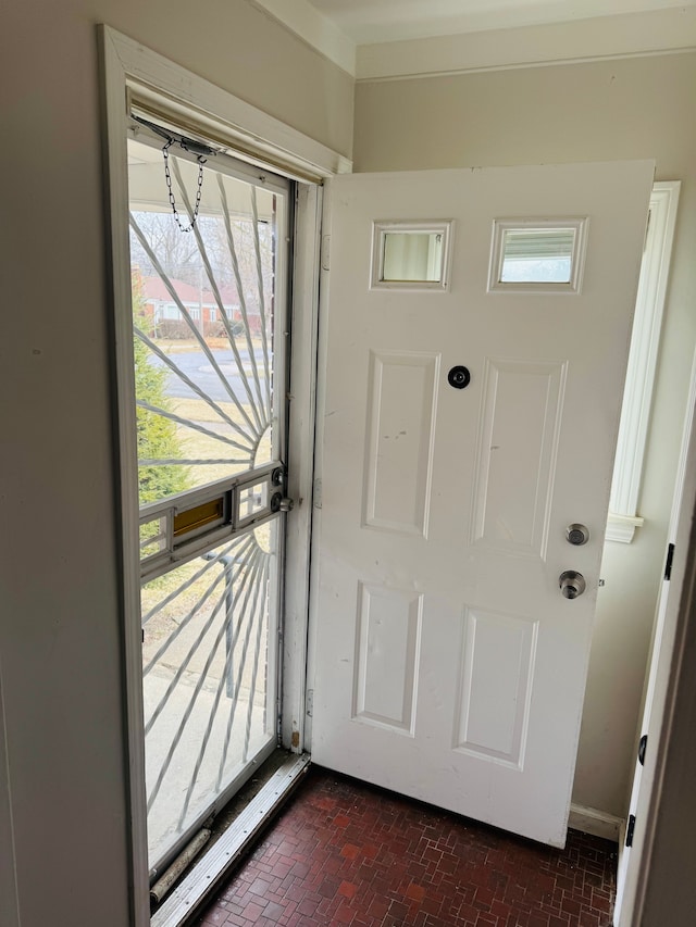 doorway featuring brick floor