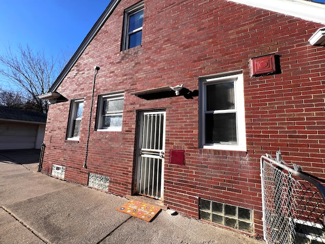 exterior space with an outbuilding and brick siding