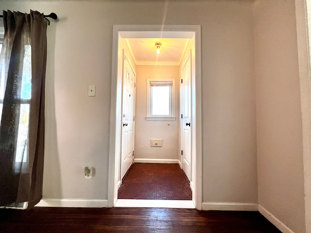 interior space featuring wood-type flooring and baseboards