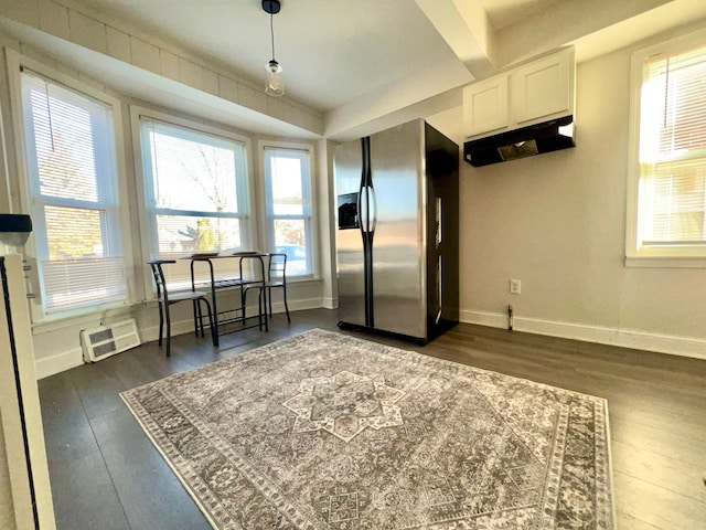 kitchen featuring dark wood-style flooring, stainless steel refrigerator with ice dispenser, and a wealth of natural light