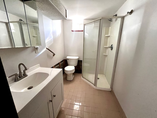 bathroom with toilet, a shower stall, and vanity