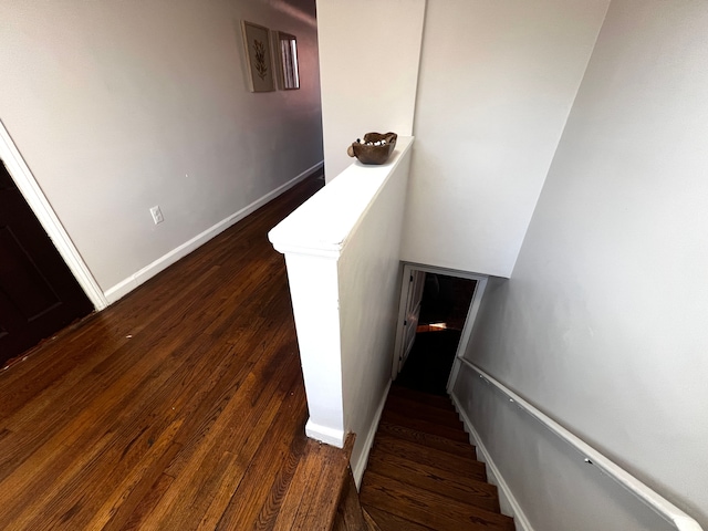 stairway featuring baseboards and wood finished floors