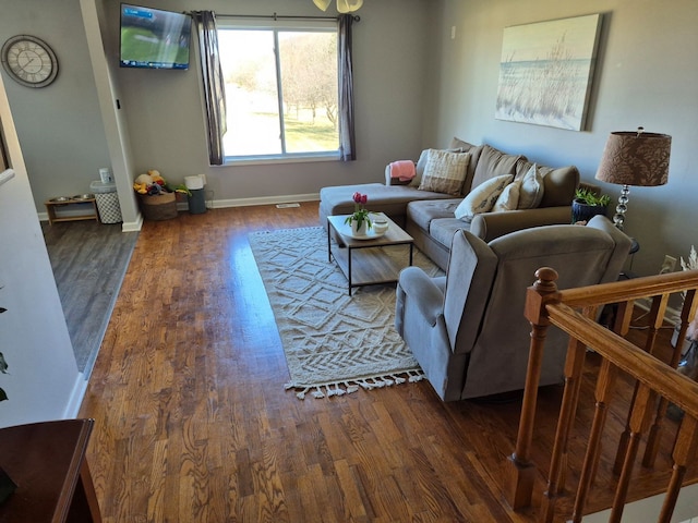 living area with wood finished floors and baseboards