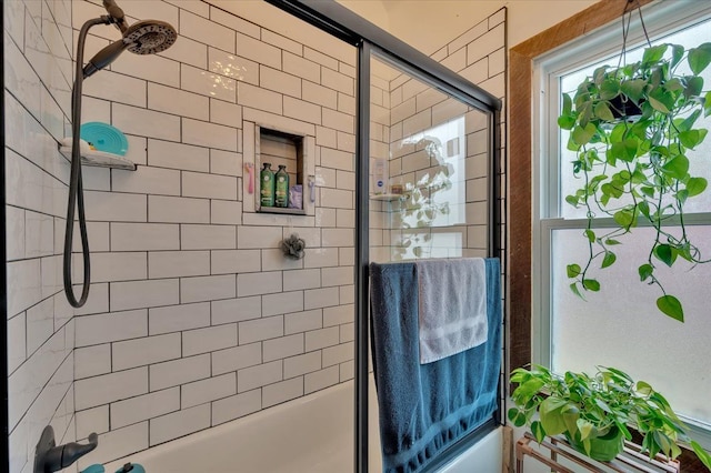 bathroom featuring shower / bath combination with glass door