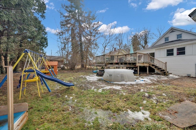 view of yard featuring a deck and a playground