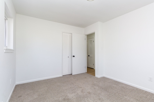 empty room with carpet floors and baseboards