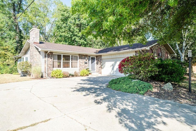 ranch-style home featuring a garage, driveway, a chimney, and brick siding