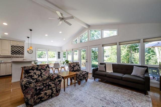 living area with high vaulted ceiling, recessed lighting, beamed ceiling, and wood finished floors