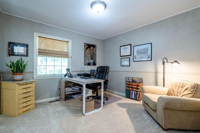 carpeted home office with ornamental molding and wainscoting