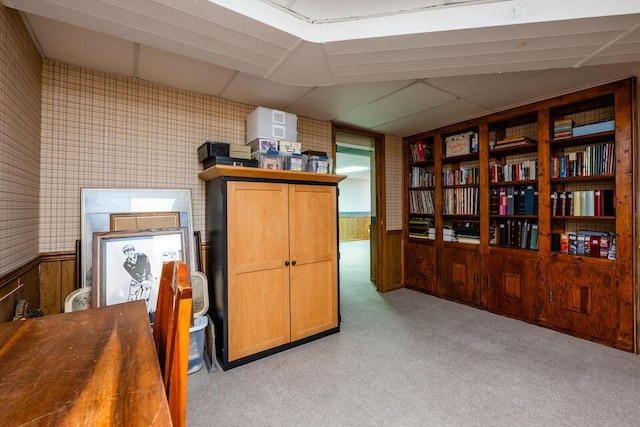 office space with wainscoting, light carpet, a drop ceiling, and wallpapered walls