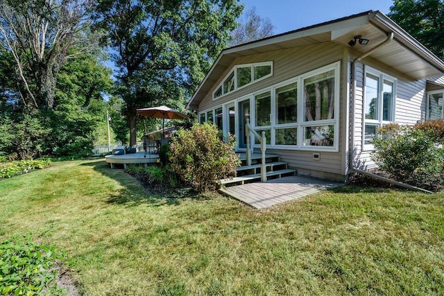 back of property featuring a yard and a wooden deck