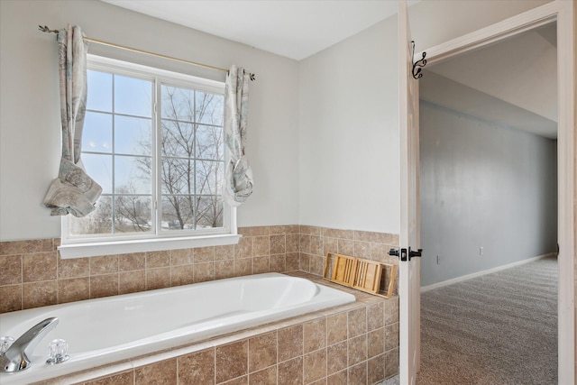 full bathroom with a garden tub and baseboards