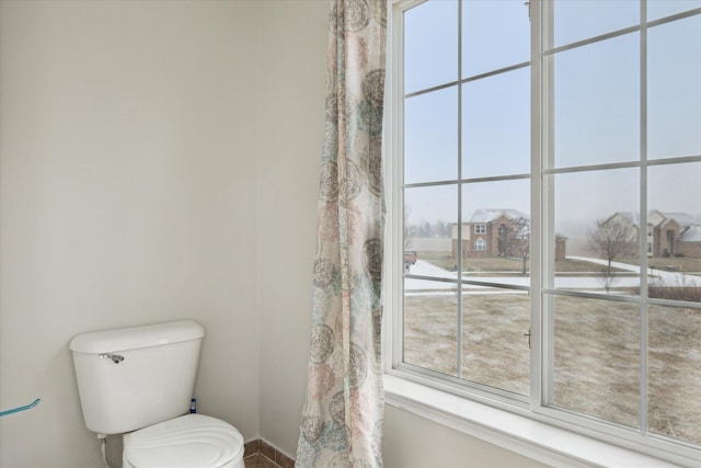 bathroom with a healthy amount of sunlight and toilet