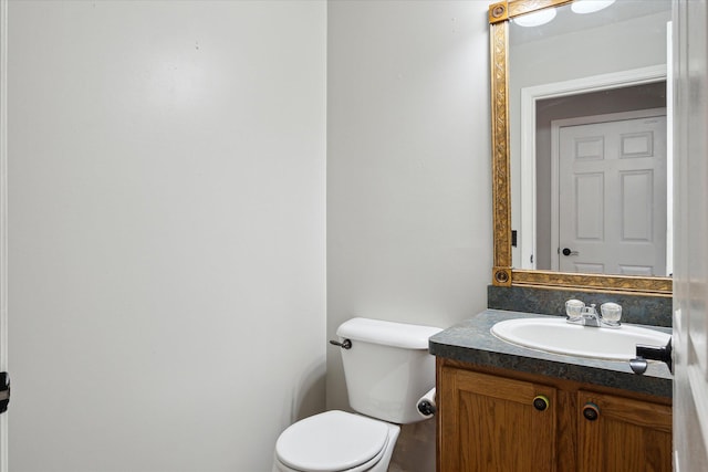 half bathroom featuring toilet and vanity