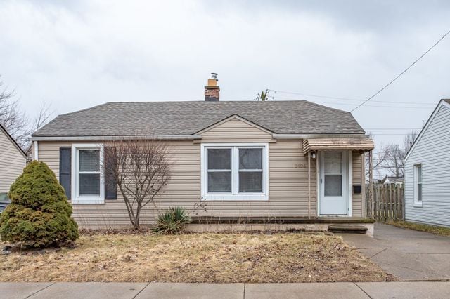 view of front of house featuring roof with shingles and a chimney