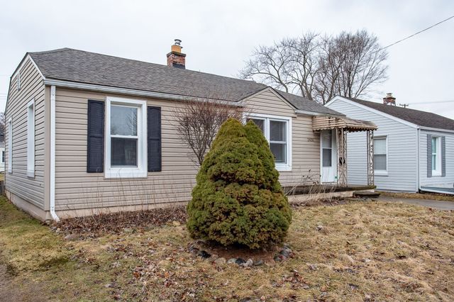 bungalow-style home featuring a shingled roof and a chimney