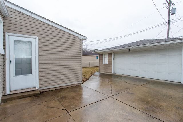 view of side of property featuring an outbuilding and a detached garage