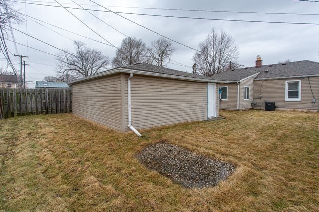 exterior space featuring a yard, cooling unit, and fence