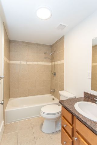 full bathroom with vanity, shower / tub combination, toilet, and tile patterned floors