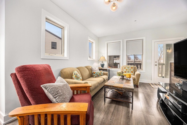 living room featuring plenty of natural light, wood finished floors, and baseboards