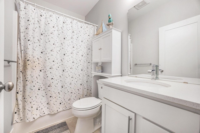 bathroom featuring toilet, vanity, visible vents, and tile patterned floors