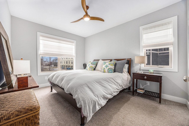 carpeted bedroom featuring ceiling fan and baseboards